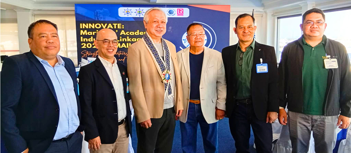 Six men in business attire pose at an innovation event, with a blue banner and logos behind them.