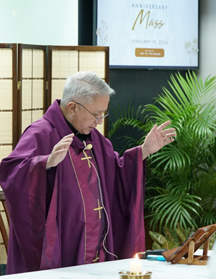 PTC marks 47 years-3 | PTC Catholic priest in purple vestments raises his hands at the altar during Mass, with a liturgical setup and plants in the background.