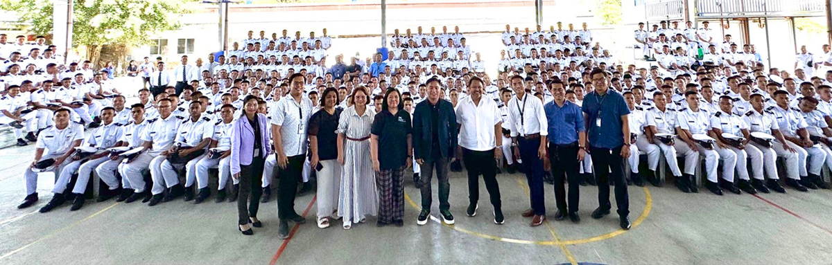 Midway Colleges | PTC Large group photo of students in white uniforms seated on bleachers outdoors, with staff members standing in front of them.