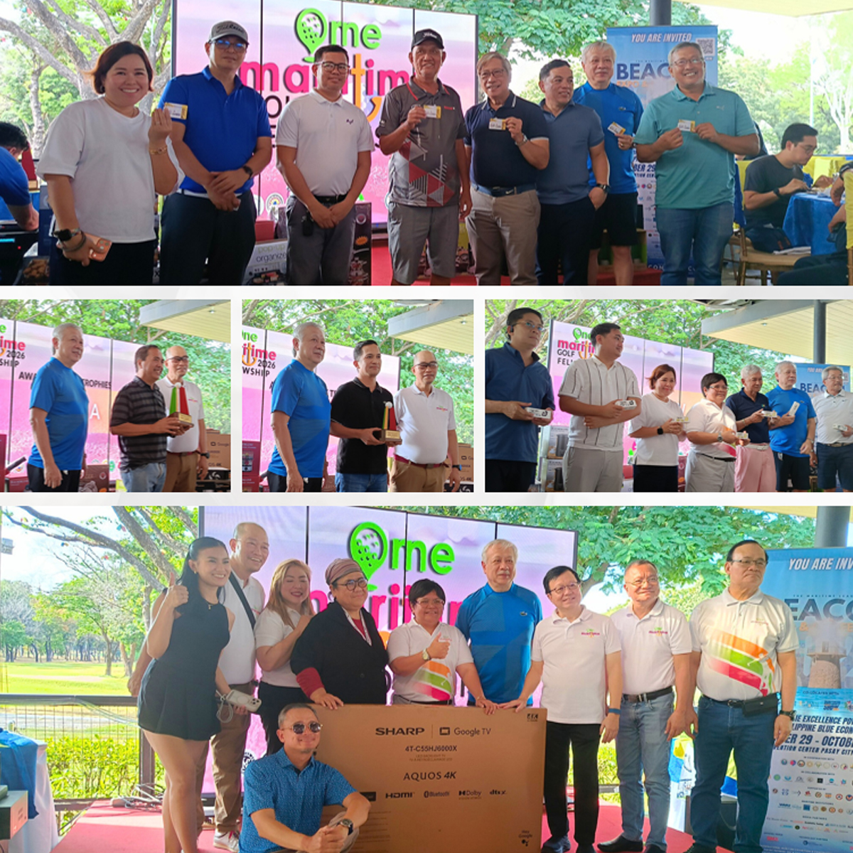 Group of diverse adults posing on a stage at an outdoor awards event, holding certificates or cards.