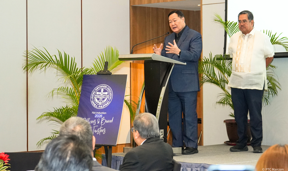 PTC reinforces industry-3 | PTC Man at a podium giving a speech on a stage, with another man standing nearby and an event banner beside him