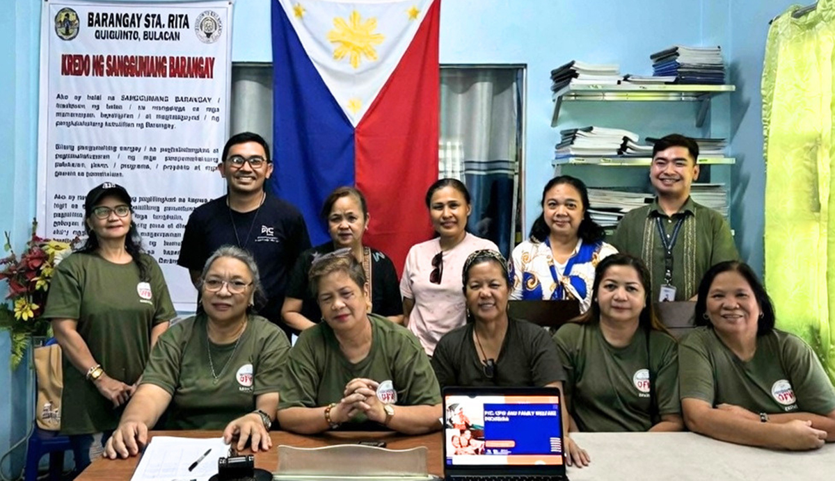 the Filipino maritime family-3 | PTC Group of people in a classroom or office posing for a photo, Philippine flag in the background and a banner on the left.