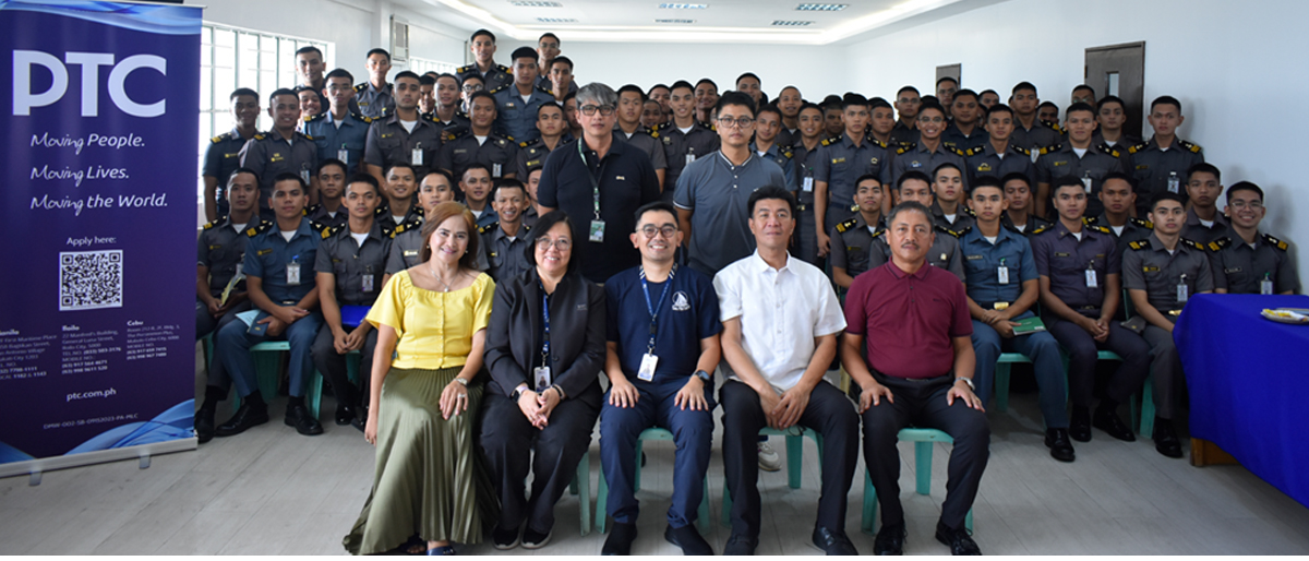 Group photo of uniformed staff with five people seated in front row; a PTC banner is on the left.