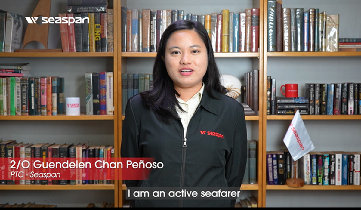 MARINA champions gender equality-4 | PTC Seaspan staff woman in a jacket stands in front of a bookshelf; red caption shows her name and role, white caption reads 'I am an active seafarer'.