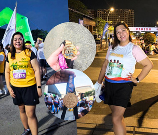 Two smiling runners pose at a night-run finish area, with a circular medal display between them.
