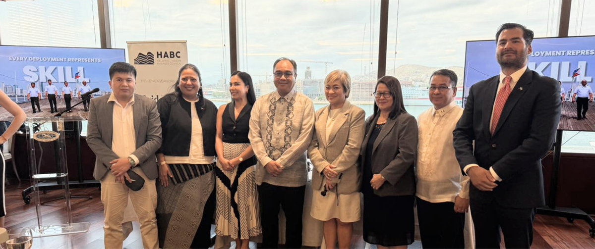 Nine professionals in business attire pose for a group photo at a skills event with SKILL and HABC banners in the background.