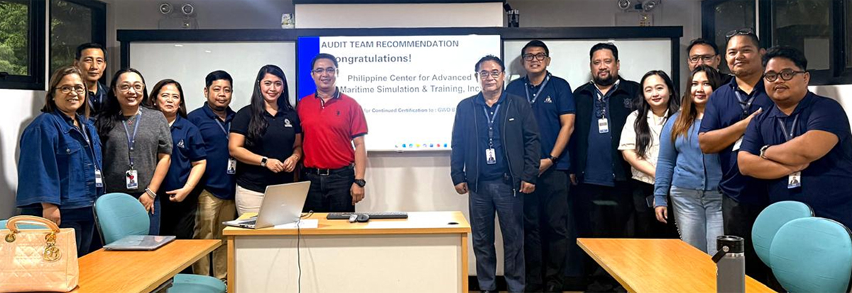 renews GWO Certification-2 | PTC Audit team of about 12–15 professionals posing in a conference room before a presentation slide reads 'Audit Team Recommendation – Congratulations'.