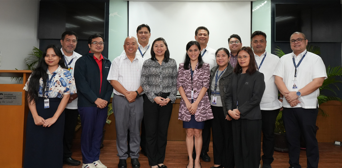 strengthens environmental commitment | PTC Group of professionals posing for a group photo in a conference room, all wearing ID badges.