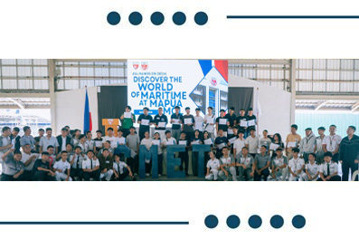 Group of people posing on a stage at a maritime expo booth with a banner reading 'Discover the World of Maritime' behind them.