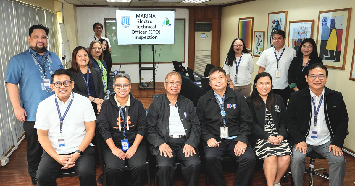 PHILCAMSAT successfully passes MARINA Accreditation-2 | PTC Group of Marina staff and inspectors posing for a photo in a meeting room, with a sign reading MARINA Electro-Technical Officer (ETO) Inspection in the background, everyone wearing badges.