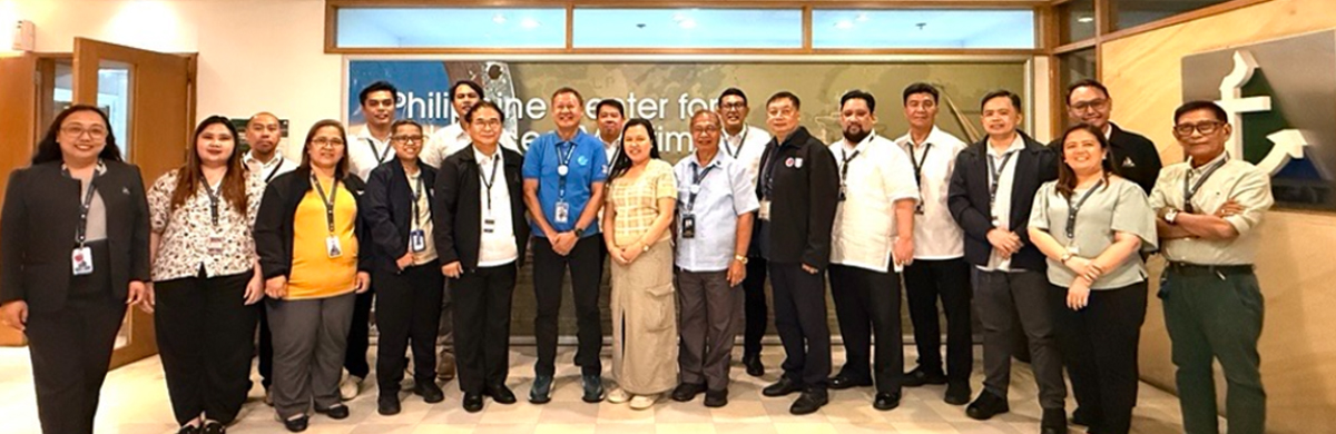 PHILCAMSAT successfully passes MARINA Accreditation-4 | PTC Group of about 20 professionals posing for a group photo in a modern office lobby, many wearing name badges and lanyards.