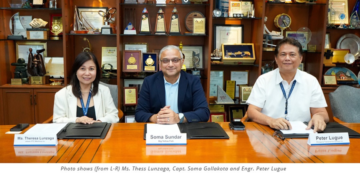 PTC JPMI and Big Yellow Fish 03 | PTC Three professionals sit at a wooden conference table with folders, in a trophy-filled office background.