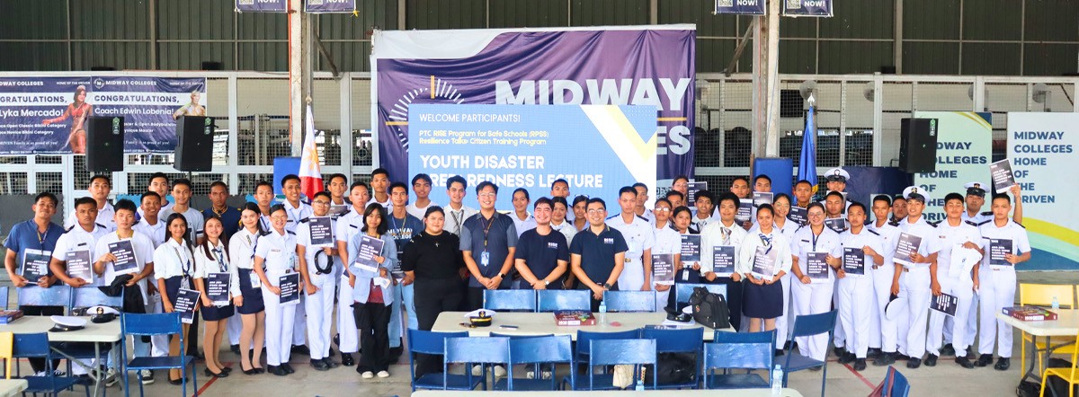 PTC RISE Program 02 | PTC Group of students in uniforms posing with certificates at a school event in a gymnasium or auditorium.